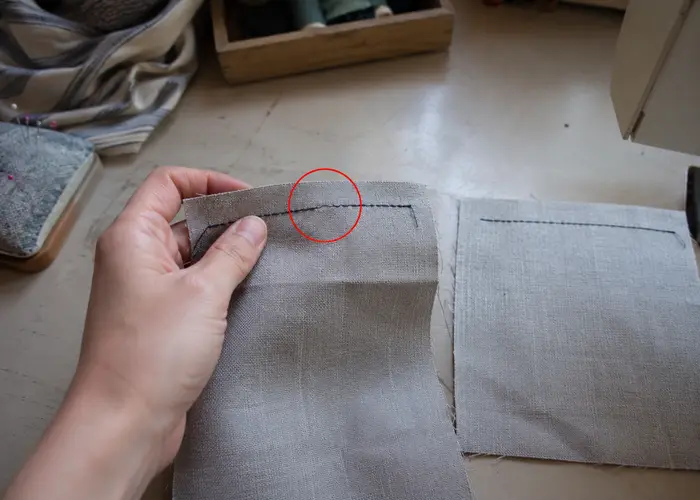 mão segurando amostra de costura para comparar o ponto onde a linha arrebentou